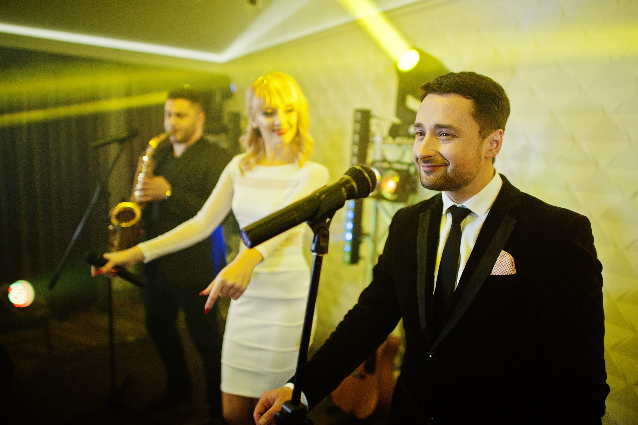 Musicial music live band performing on a stage with different li